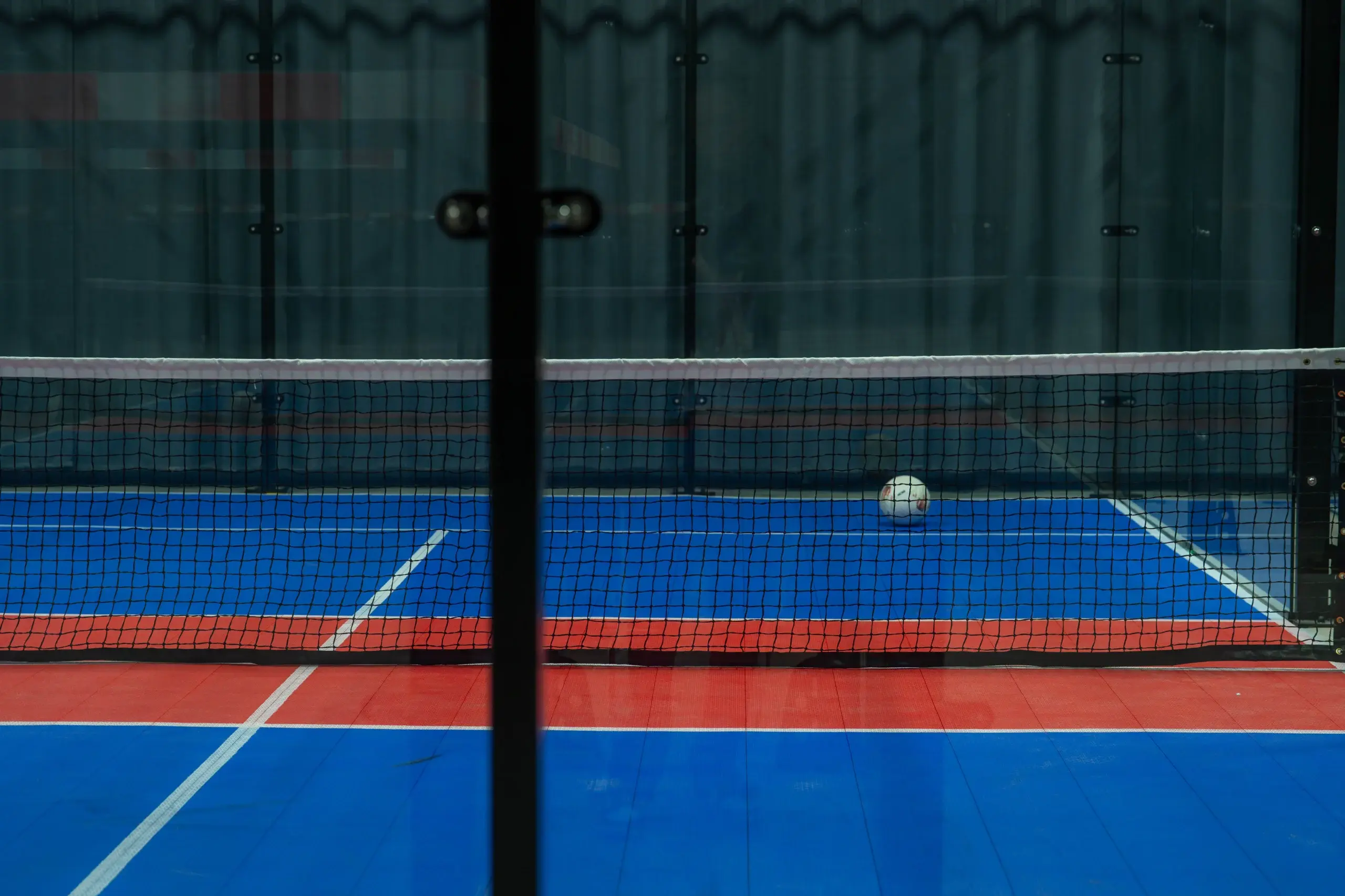 Voetbal op de kunstgrasvloer van een voetpadelveld